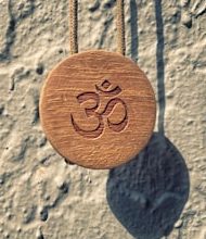 What is the relationship of ‘ॐ’ with the universe?