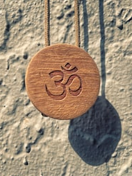 What is the relationship of ‘ॐ’ with the universe?