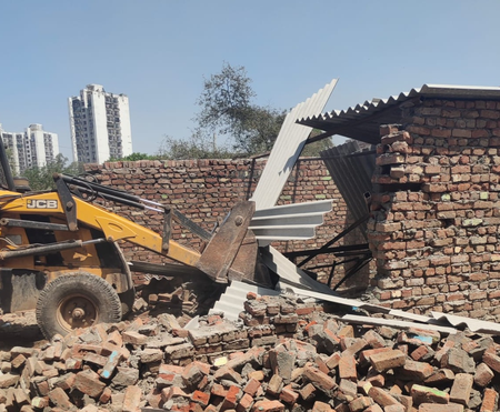 NEIDA AUTHORITY management bulldozers on illegal construction, 8 crore land evacuated