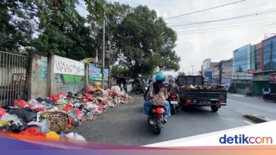 Residents upset the stacks of garbage make a narrow road in Cimanggis Depok
