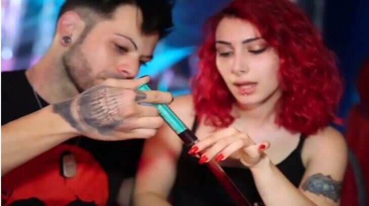 Man and woman drink each other’s blood to express love
